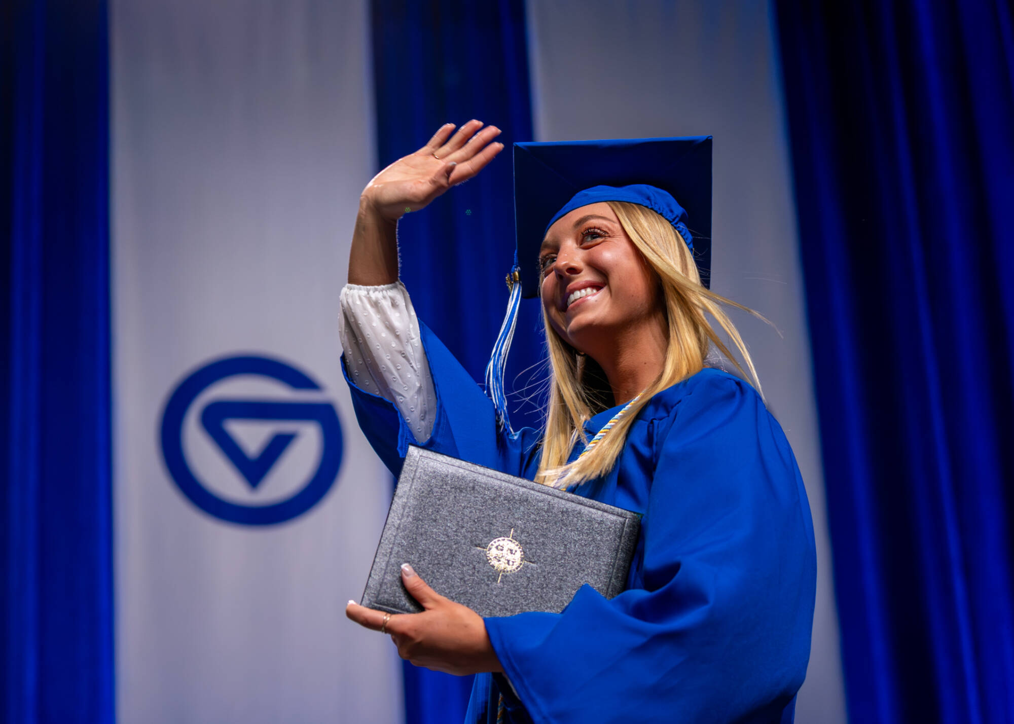 Student holding their degree.